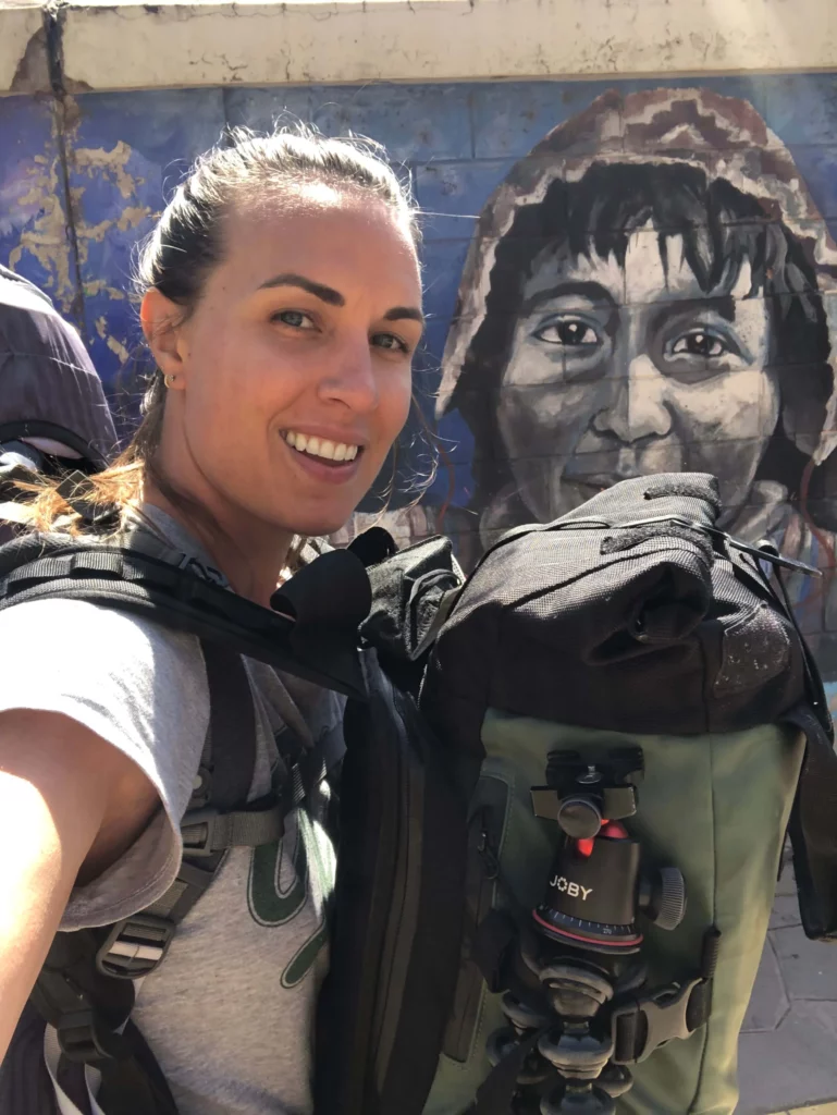 solo female traveler wearing two backpacks while traveling