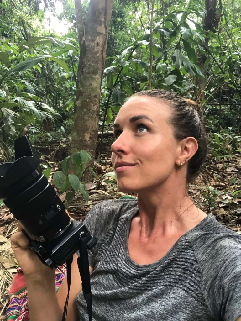solo female traveler taking photos in the amazon jungle travel photography gear list