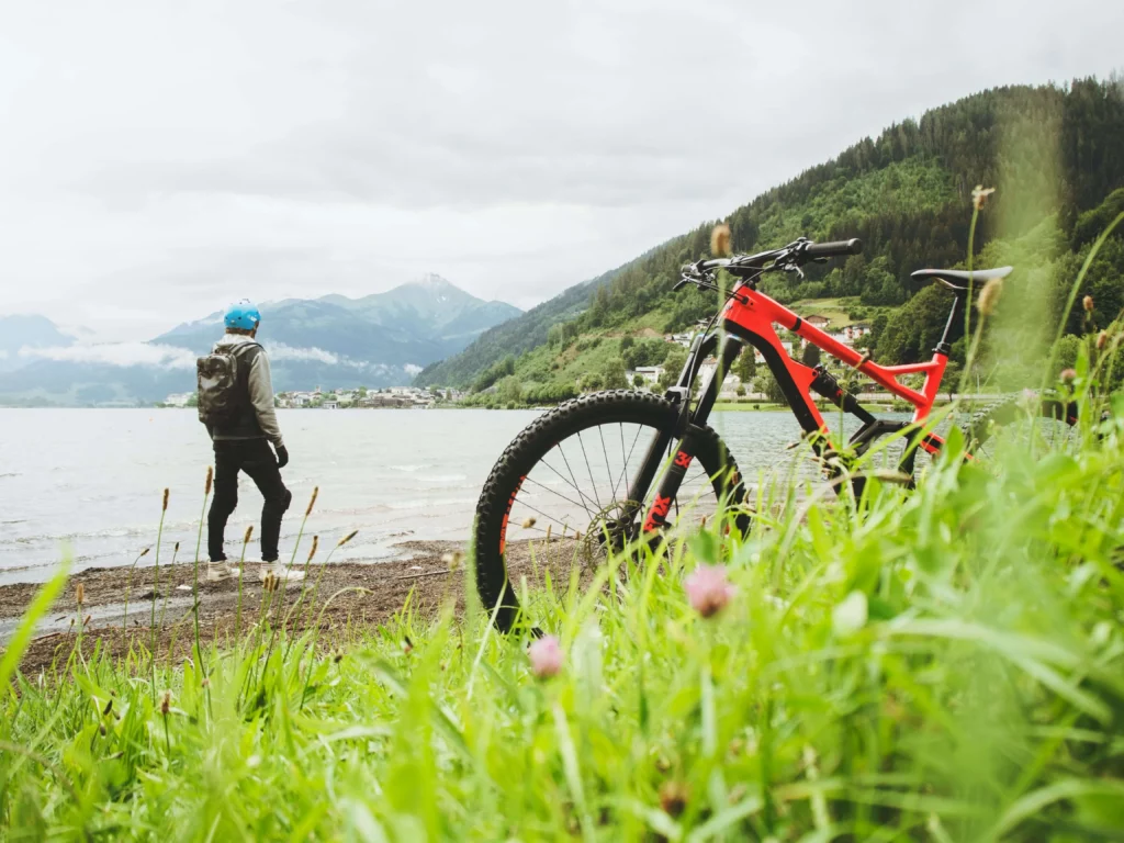 mountain bike man standing at edge of lake best things to do bariloche