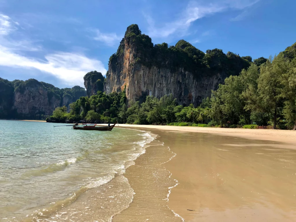 railay beach rock cliff longtail boat best places to visit in thailand