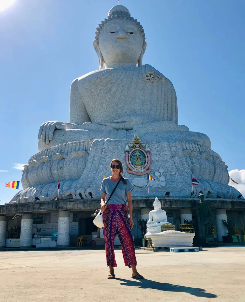 solo female traveler standing big buddha statue phuket thailand