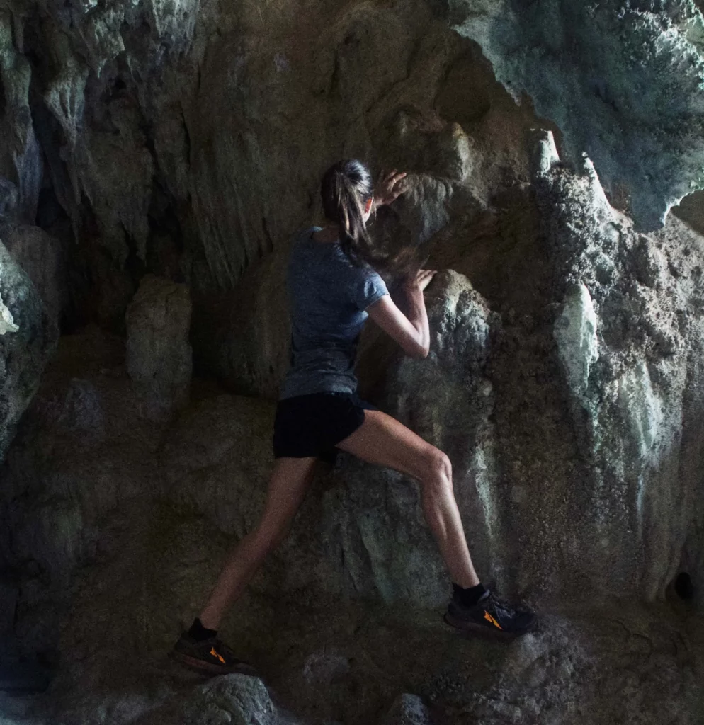 solo female traveler rock climbing cave railay thailand