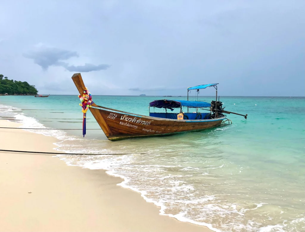 traditional thai longtail boat on shore