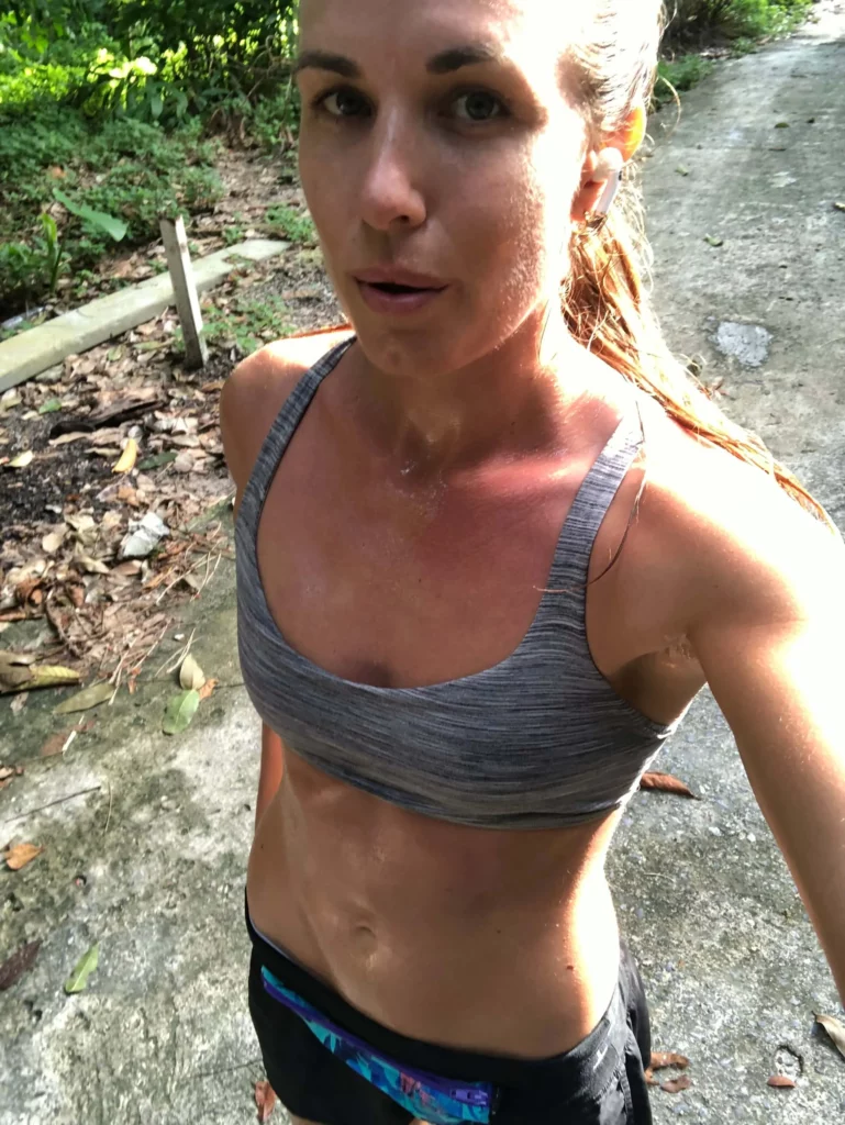 woman sweating wearing sports bra shorts