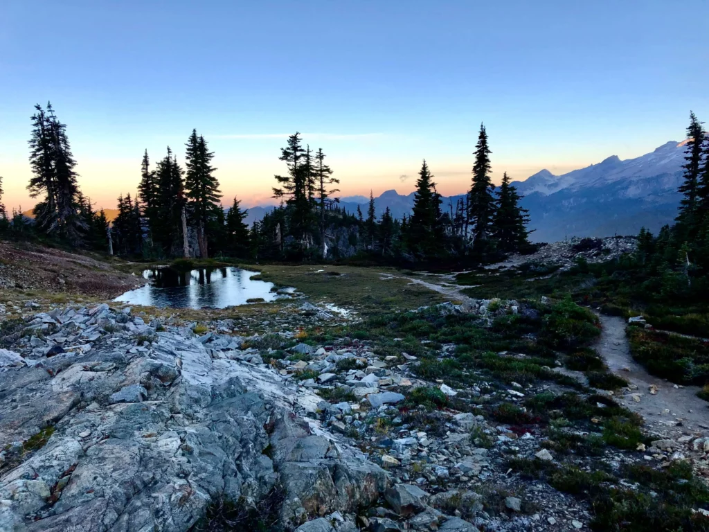 hiking for beginners trail view lake trees mountains