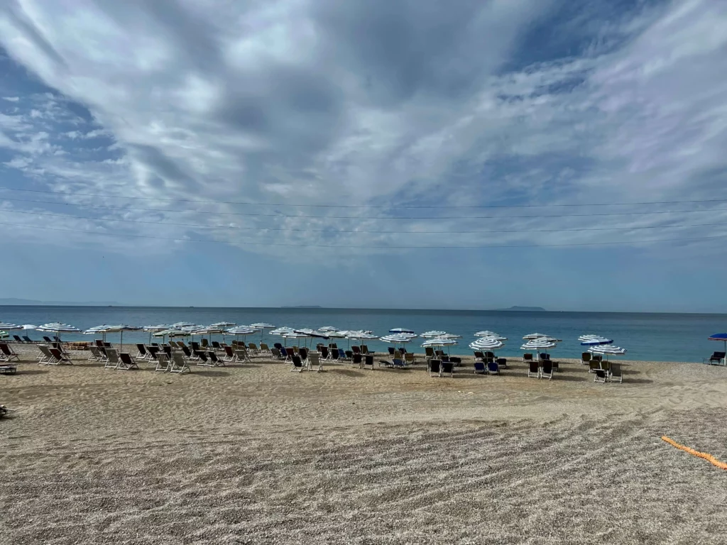 gjipe beach albania sun chairs umbrellas