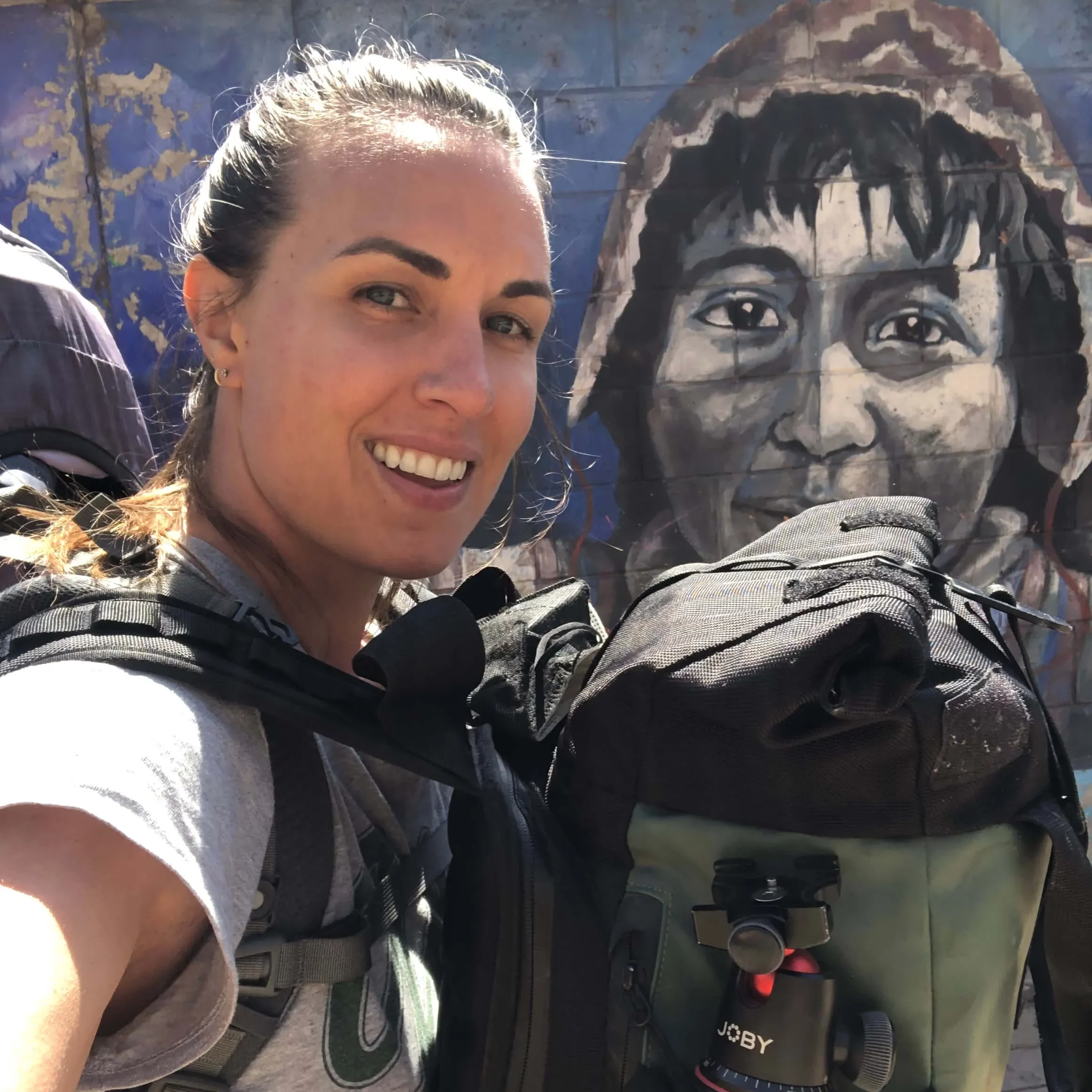solo female traveler wearing two backpacks while traveling
