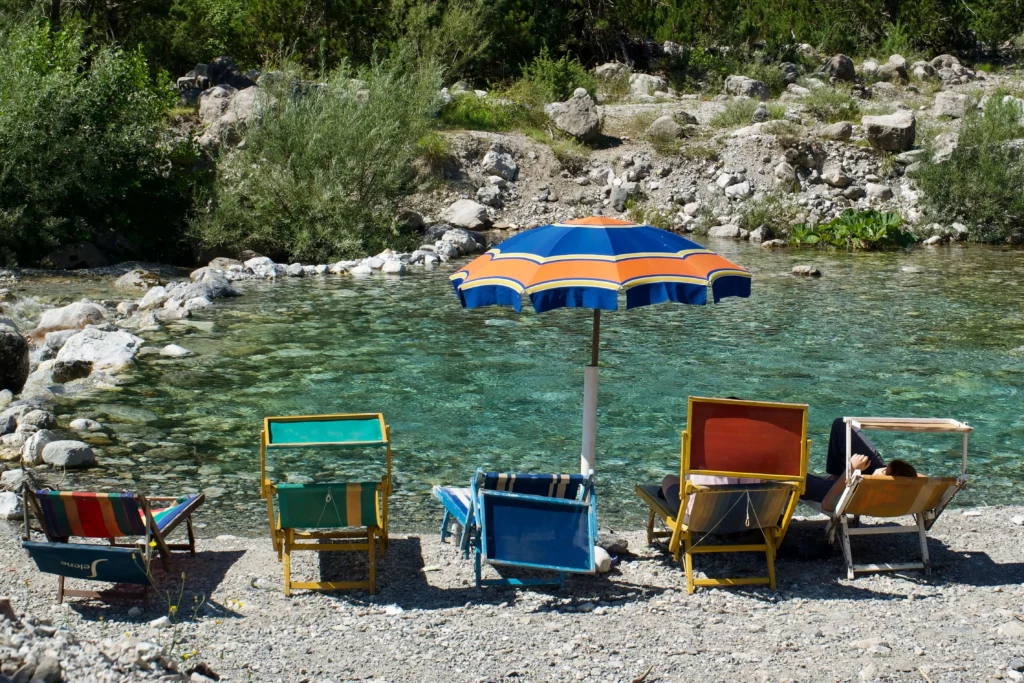 theth albania sun chairs umbrella river