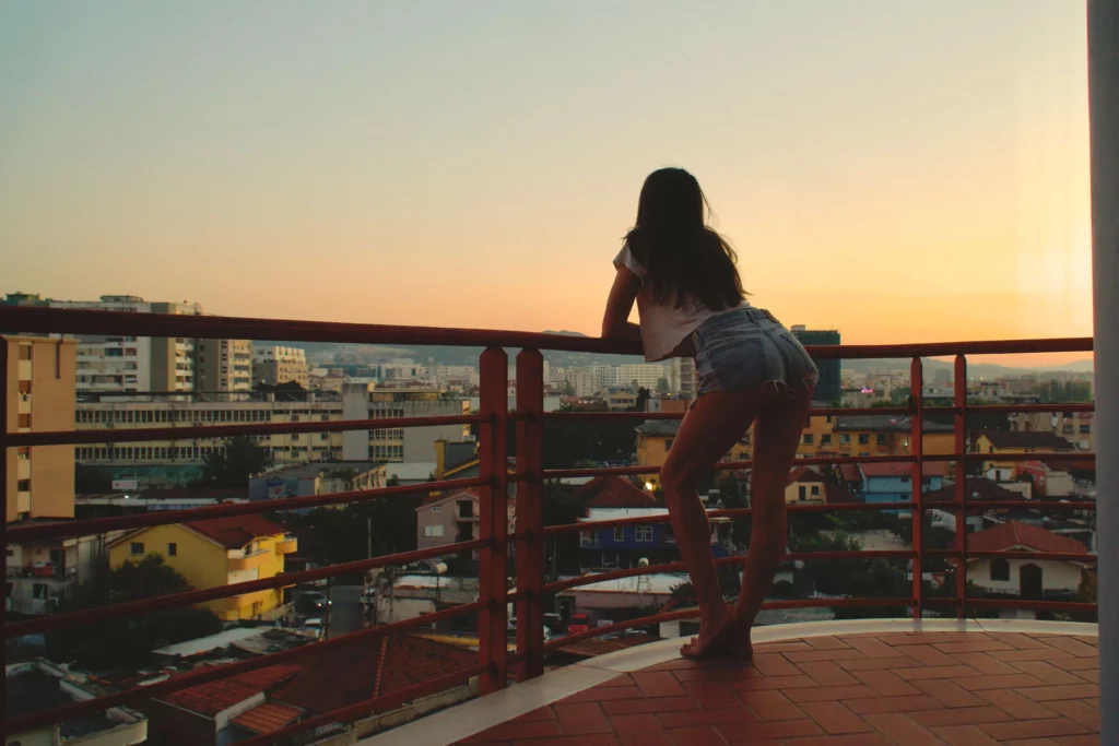 tirana albania woman balcony cityscape